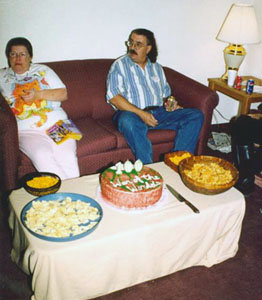 Jan Lockett and Curt Stubbs, with the cake and goodies on the table